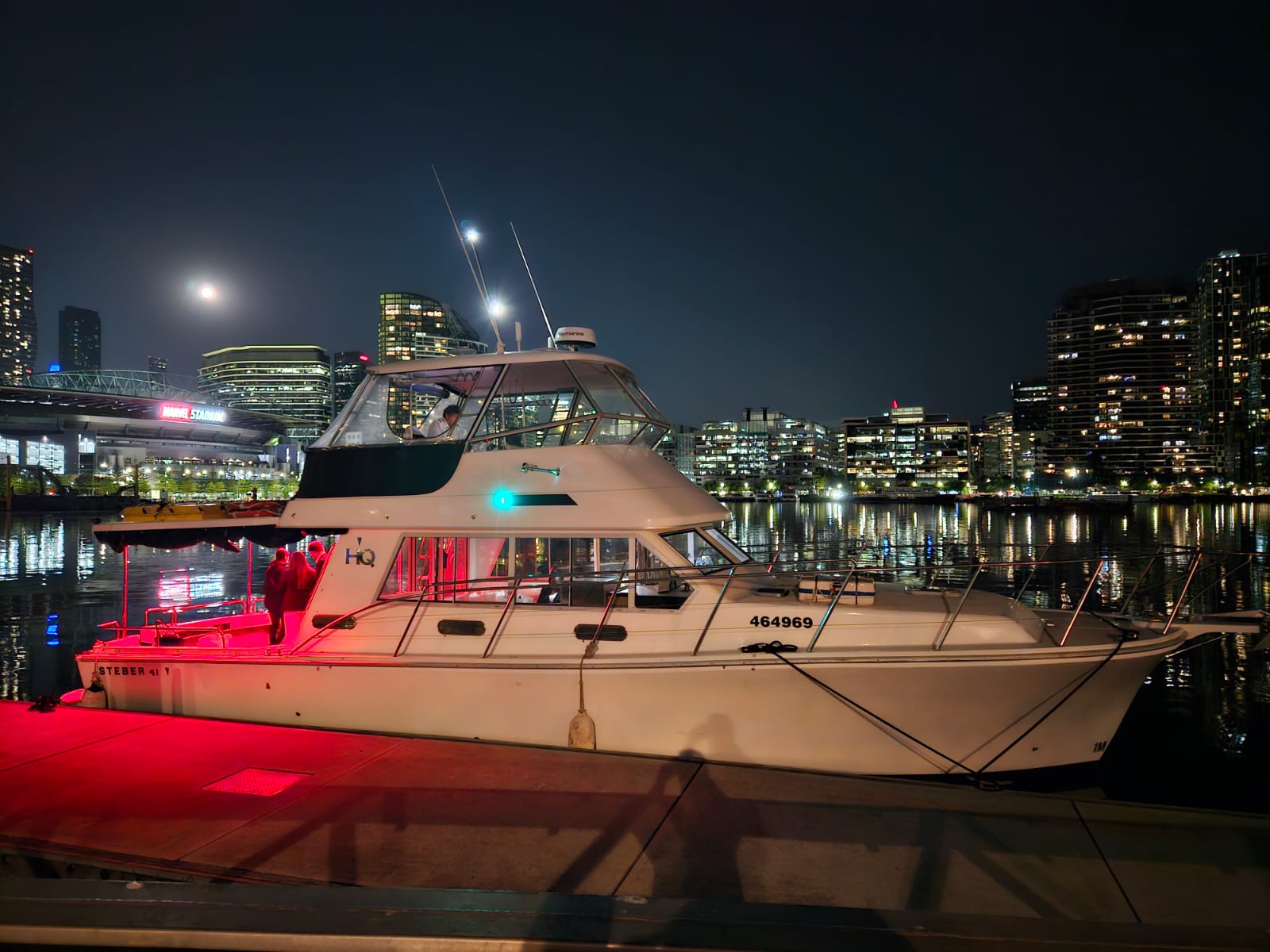 Corporate staff enjoying a private party boat hire Melbourne cruise on the Yarra River at sunset